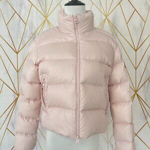 This Moncler pink down jacket features a mini-puffy design, offering warmth and